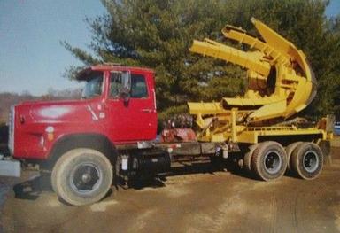Yellow And Red Truck Mounted Tree Tranter
