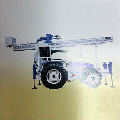 White & Blue Tractor Mounted Drilling Rig