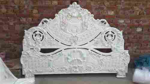 wooden carved bed in white deco
