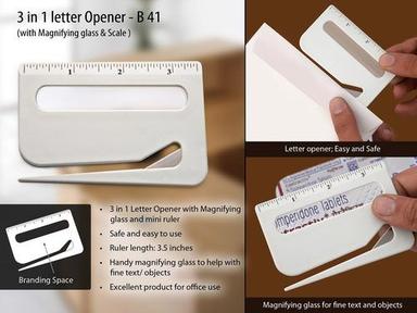Letter opener with magnifier and ruler